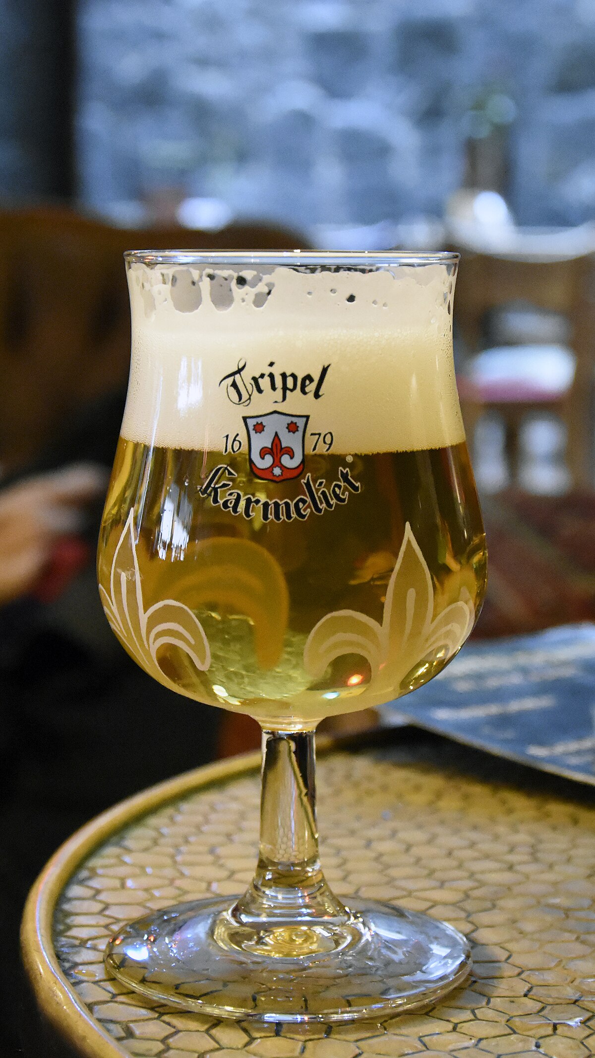 Tripel Karmeliet in its signature glass, golden-blonde with a thick ivory head